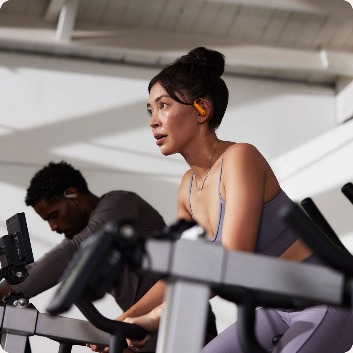 Person wearing Powerbeats Pro 2 earbuds, working out