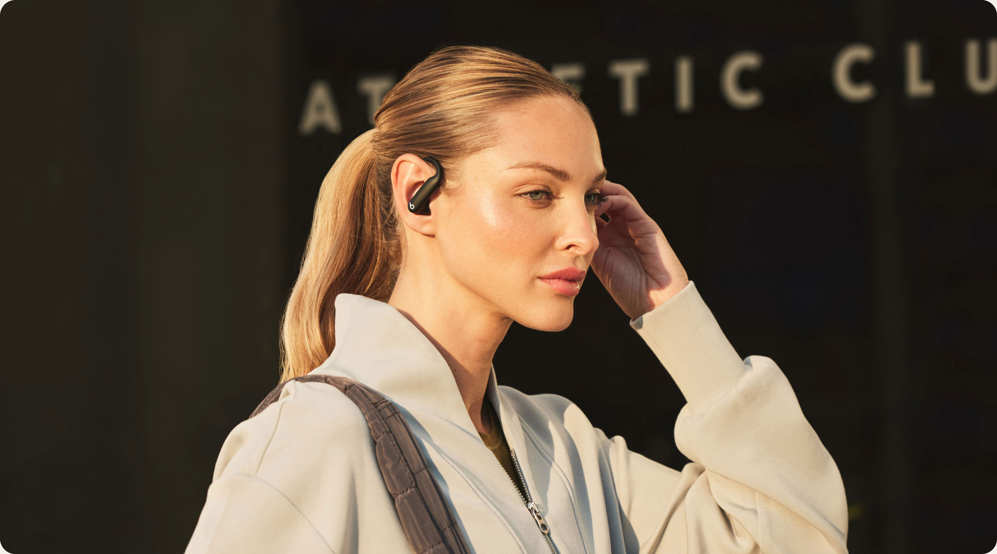 Person wearing Powerbeats Pro 2 earbuds